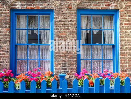 Victorian terraced brick town cottage front with garden flowers. Stock Photo