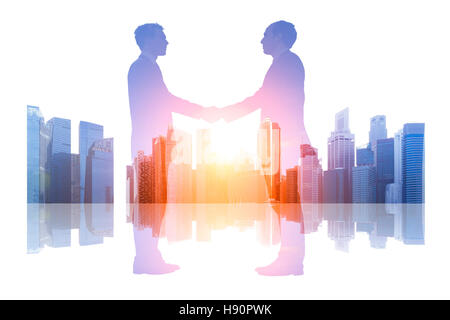Double exposure of business people shaking hands over a cityscape background, handshake, skyline, concept agreement, partnership Stock Photo