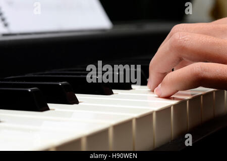 Close up of Child's hands playing piano Stock Photo