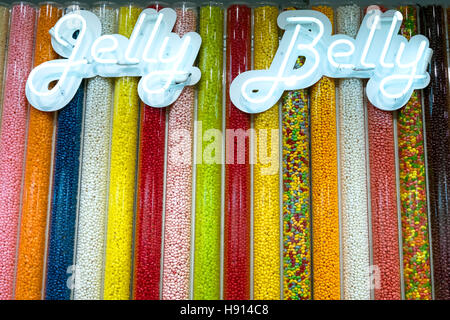 A display of multi-coloured varieties of jelly beans in clear vertical tubes seen in sweet shop, UK Stock Photo