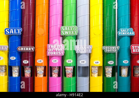 A display of varieties of popcorn flavours, SALT, CHERRY, SWEET, FRUITS, LUXURY TOFFEE, COCONUT, in coloured vertical tubes Stock Photo