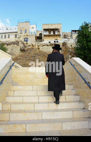 Religious man climbing on stairs in Safed, Israel Stock Photo