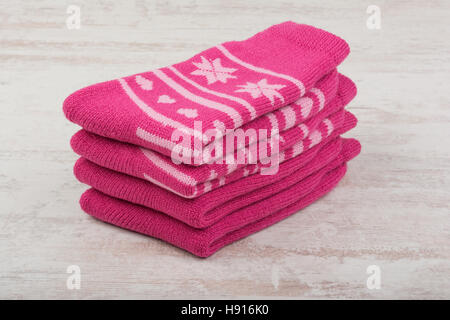 Pink woolen socks on white wooden background Stock Photo