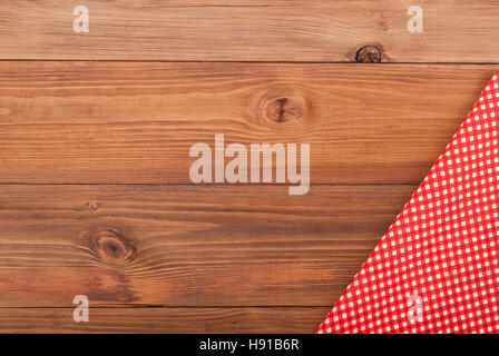 Red checkered cloth on a wooden table. Stock Photo