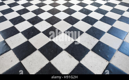 Retro stone floor tiling with black and white checkered pattern Stock Photo