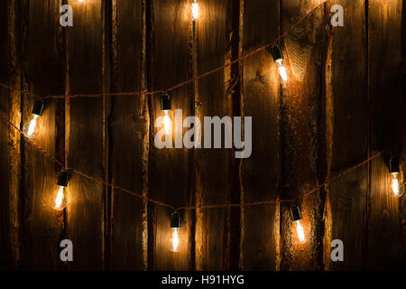 Designer light bulbs on dark wooden background Stock Photo