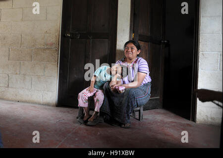 Maya indigenous mother and daughter at home in Chuk Muk, Solola, Guatemala. Stock Photo
