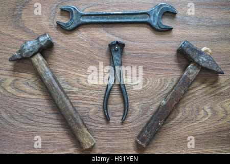 Ornament of old tools on a wooden background. Different tools. Hand tools. Stock Photo