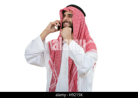 Side view of an arab saudi emirates man using a smart phone. Stock Photo