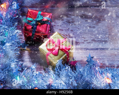 close up view of christmas tree garlend and gift boxes  on wooden back Stock Photo