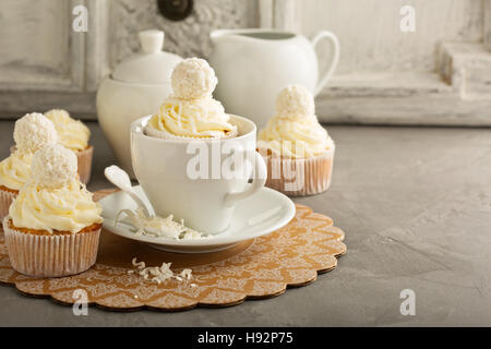 Coconut cupcakes with white frosting Stock Photo