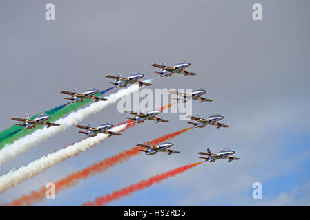 Italian Air Force Frecce Tricolori aerobatic display planes, Red Arrows, fly in cloudy weather Stock Photo