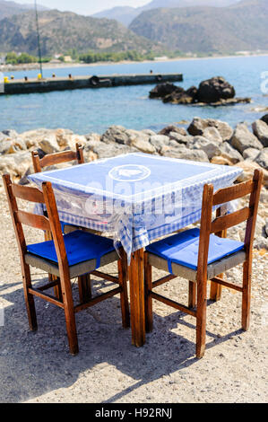 Wooden chairs and tables at traditional Greek tavern Stock Photo