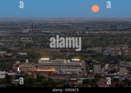 Hunter Moon rises above Folsom Field, the CU campus and parts of Boulder Stock Photo