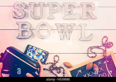 Game day football party table. Watching game on VR goggles. Stock Photo