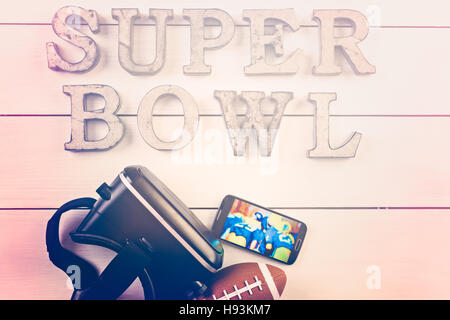 Game day football party table. Watching game on VR goggles. Stock Photo