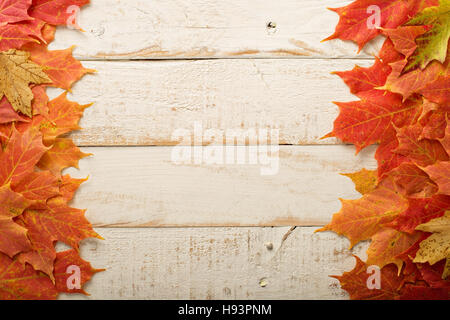 Fall leaves frame on whooden background Stock Photo