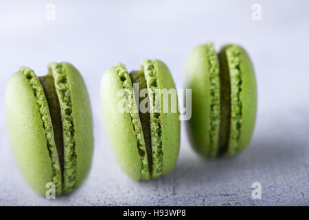 Three green french pistachios Macaroons on a table Stock Photo