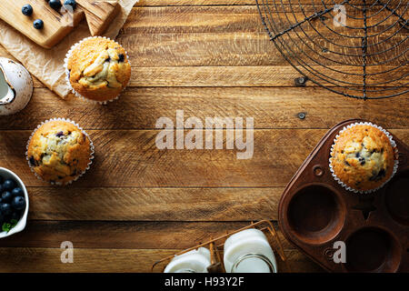 Freshly baked blueberry muffins in a rustic setting Stock Photo