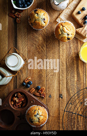 Freshly baked blueberry muffins in a rustic setting Stock Photo