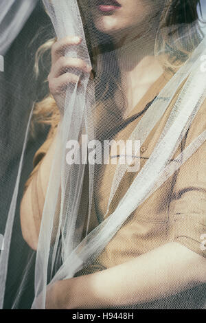 Close up of an anxious woman hand grabbing the blinds Stock Photo