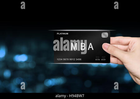 hand picking MBA or Master of Business Administration platinum card on blur background Stock Photo