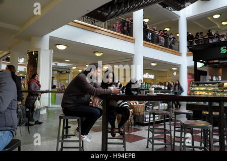 A couple having a cup of coffee in the indoors shopping centre in Croydon. Stock Photo