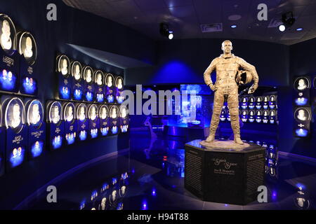 A statue of NASA astronaut Alan Shepard at the Heroes and Legends attraction stands inside the doors to the U.S. Astronaut Hall of Fame at the Kennedy Space Center Visitor Complex November 7, 2016 in Titusville, Florida. Shepard was the first American in space. Stock Photo