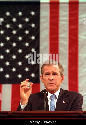 U.S. President George W. Bush holds up the badge of a Port Authority Police officer killed in the September 11 attacks during his address to Congress at the U.S. Capitol September 20, 2001 in Washington, DC. Stock Photo