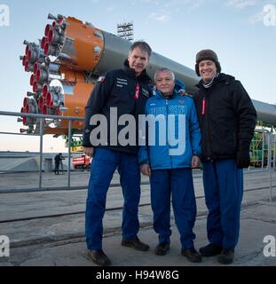 NASA International Space Station Expedition 50 backup crew members (L-R), Italian astronaut Paolo Nespoli of the European Space Agency, Russian cosmonaut Fyodor Yurchikhin of Roscosmos, and American astronaut Jack Fischer pose in front of the Soyuz MS-03 rocket as it is rolled to the Baikonur Cosmodrome launch pad November 14, 2016 in Baikonur, Kazakhstan. Stock Photo