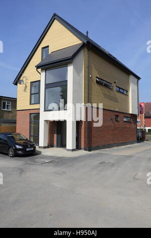 Exterior of a new super-insulated home in west London, UK. Fished in brick, concrete render and architectural cladding panels Stock Photo