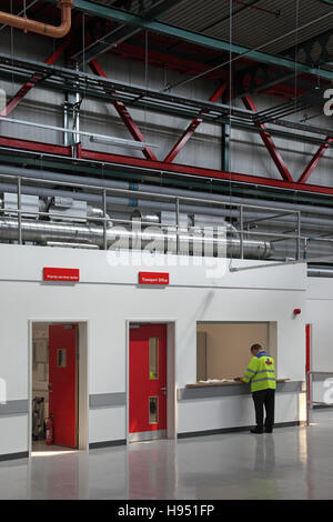 A single worker waits at the Transport Office reception in a new Post Office sorting office in Southern England, UK Stock Photo