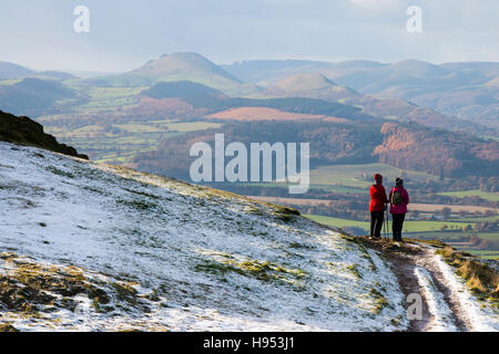 The Wrekin, UK. 18 November 2016. Walkers Sue Raffe and Margaret Lewis, from Shifnal, Shropshire, look out over the Shropshire Hills from a snow-covered Wrekin. Credit:  John Hayward/Alamy Live News Stock Photo