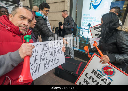 London, UK. 18th November 2016. Cleaners from the Independent Workers Union CAIWU get out posters for a protest at Claranet's offices in Holborn, where they are employed by NJC under contract to Claranet. NJC & Claranet have ignored the union's attempts to negotiate for the London Living Wage and have confirmed they have no intention of considering moving to the living wage. NJC has suggested that CAIWU members might be moved to other sites which do pay the living wage, but the CAIWU say this is not acceptable. They call on Claranet which claims to be an ethical company to insist the cleaners Stock Photo