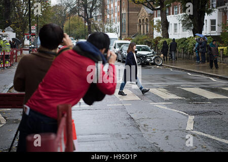 London, Great Britain. 12th Nov, 2016. Tourists photograph the famous crosswalk outside Abbey Road Studios in London, Great Britain, 12 November 2016. The tourists are making a reference to the cover of the album 'Abbey Road' by the Beatles. Photo: Wolfram Kastl/dpa/Alamy Live News Stock Photo