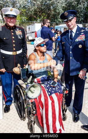 Miami Beach Florida,Veterans Day,celebration activities,disabled,wounded veteran,wheelchair,decorated,dress uniforms,Marine Corp,Air Force,shaking han Stock Photo