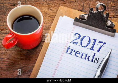 2017 trends on a  clipboard with coffee against grunge wood desk Stock Photo