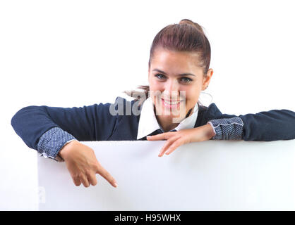 advertising banner sign - woman excited pointing on empty blank billboard paper sign board. Young business woman isolated on white background. Stock Photo