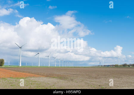 row wind turbines in an agricultural dutch landscape Stock Photo