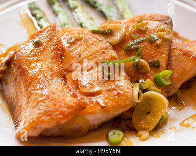 Loins grilled salmon served with asparagus and strips of green peppers Stock Photo