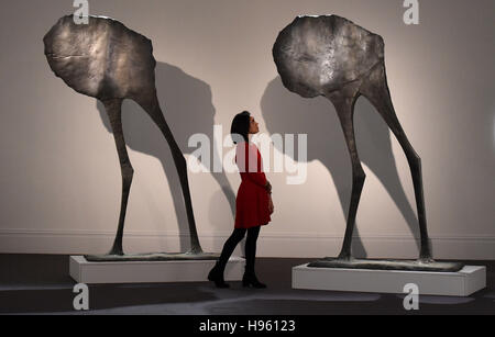 Staff at Sotheby's, London, stand next to sculptures titled Mirage II by Dame Elisabeth Frink in the Modern & Post-War British Art section and estimated at £120,000 - £180,000, which make up part of Sotheby's forthcoming National Treasures auctions. Stock Photo
