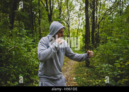 the man in the woods,training in Boxing Stock Photo