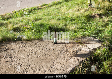 bottle of beer on the ground Stock Photo