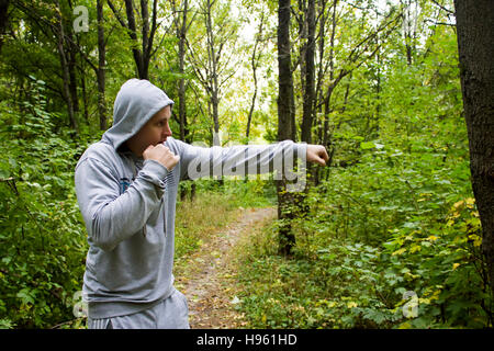 the man in the woods,training in Boxing Stock Photo