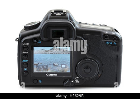 LCD screen on back of a Canon 5D mk II digital SLR camera showing a photograph of a coastal outdoor scene. Isolated on white Stock Photo