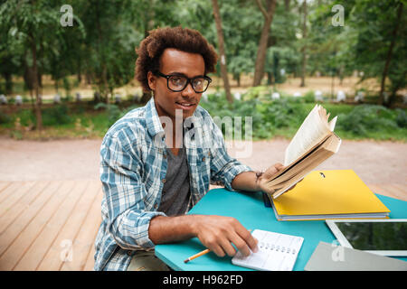 Happy attractive african young man studying outdoors Stock Photo