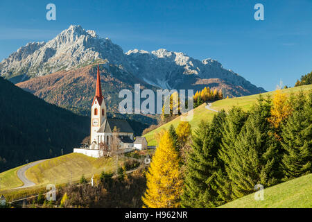 Autumn morning at the iconic church of Sankt Nikolaus in Winnebach, South Tyrol, Italy. Dolomites. Stock Photo