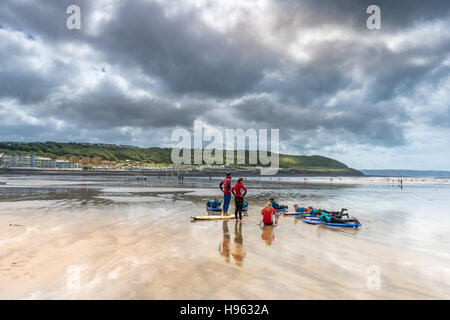 A surf lesson run by the North Devon Surf School gets underway on the beach at Westward Ho! in north Devon. Stock Photo