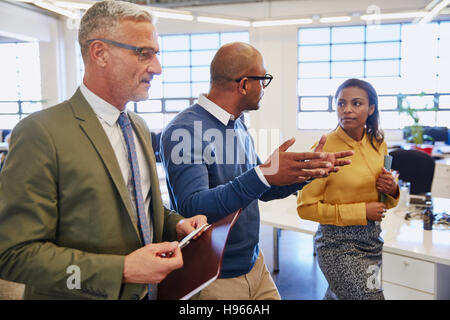Business people walking and talking in office Stock Photo