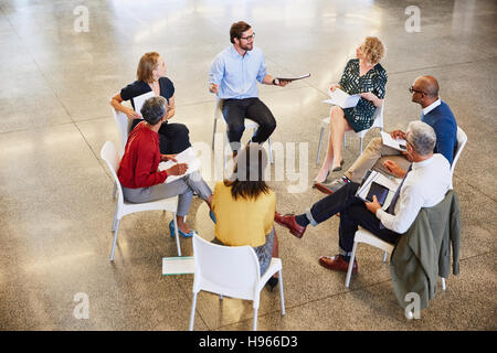 Business people talking in circle meeting Stock Photo